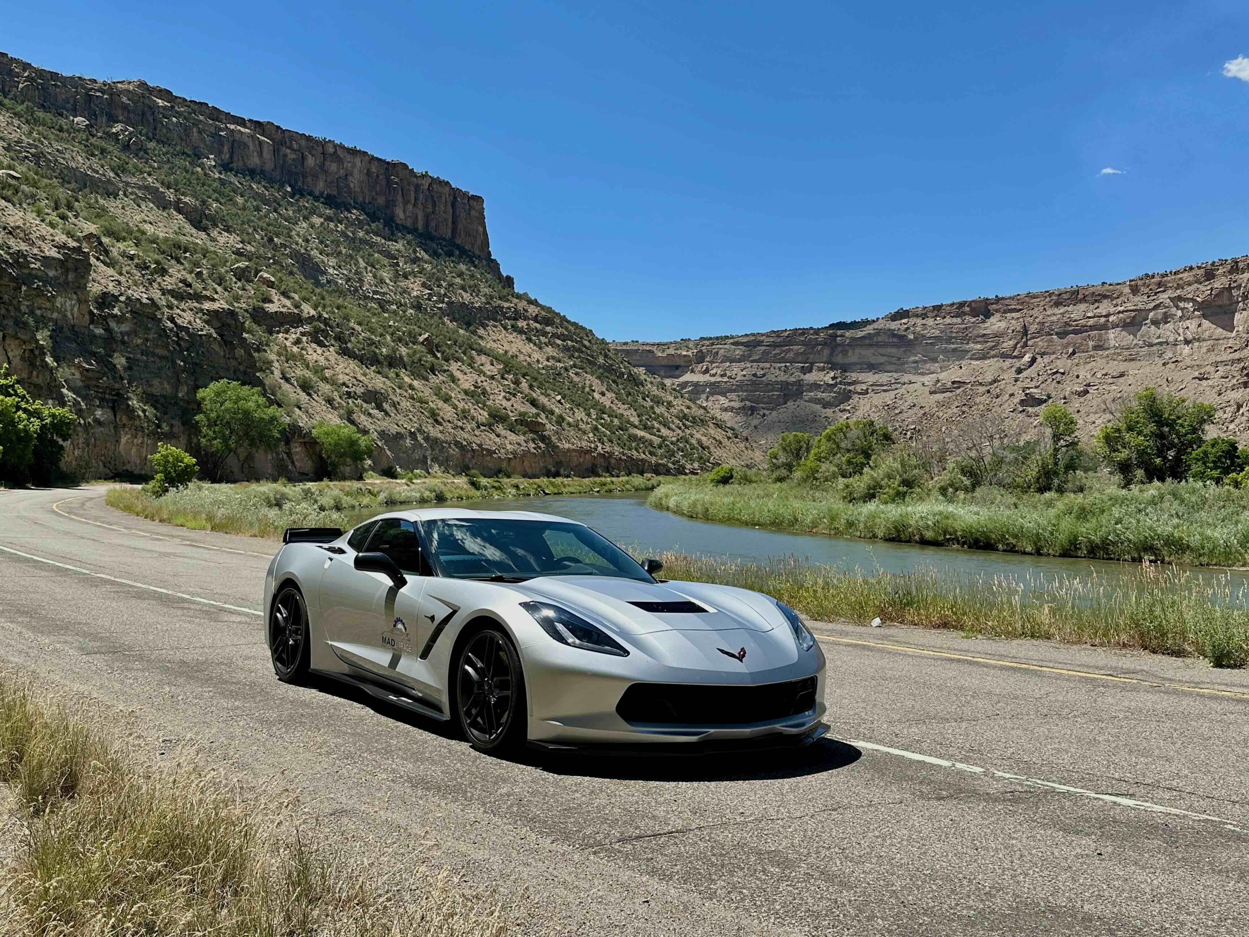 Silver Corvette on road